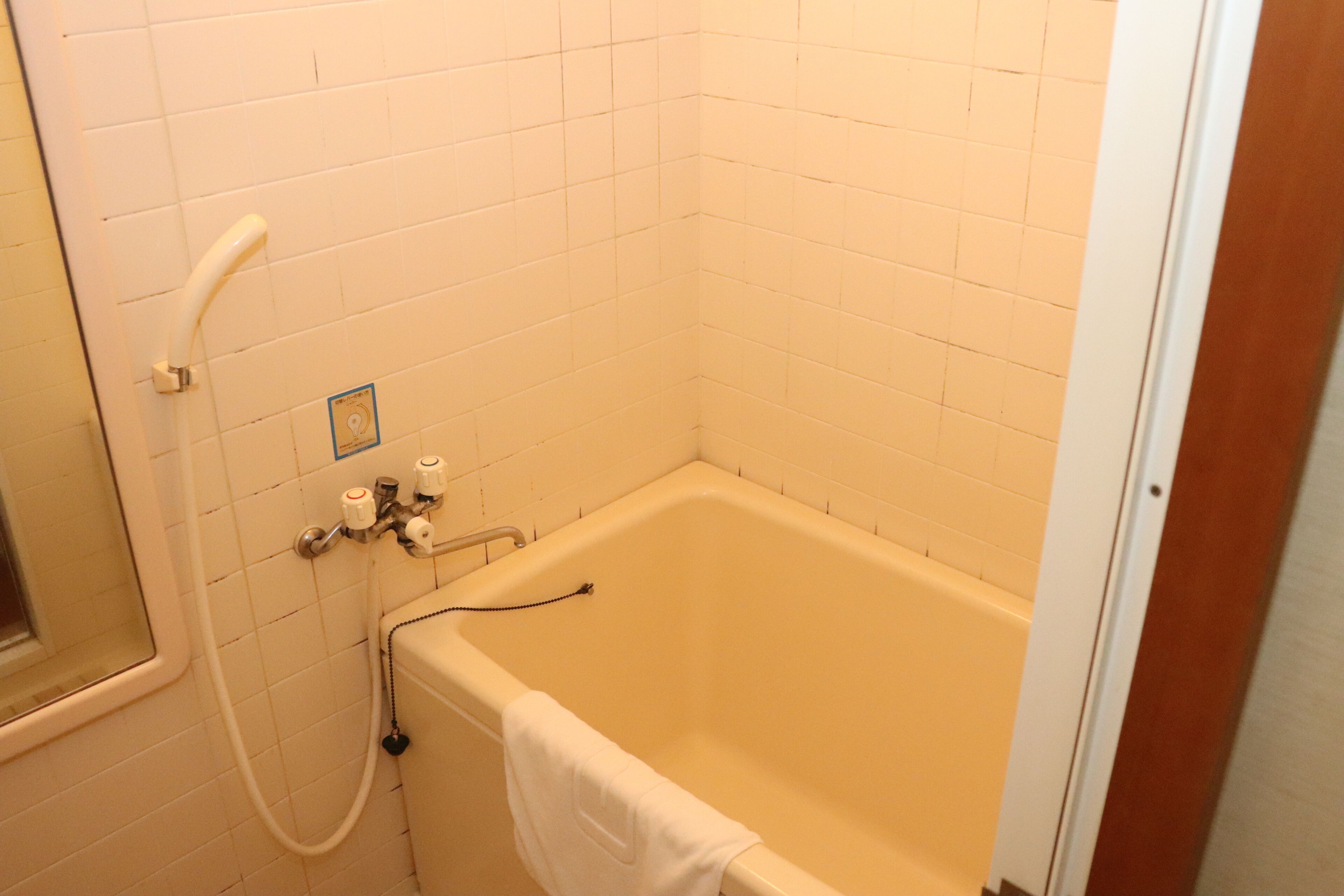 A bathroom with a bathtub, a shower, and a toilet.