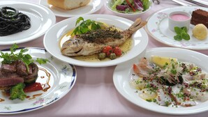A table with various dishes including fish, bread, and salad. - Country Inn The White Marine (Tonosho)