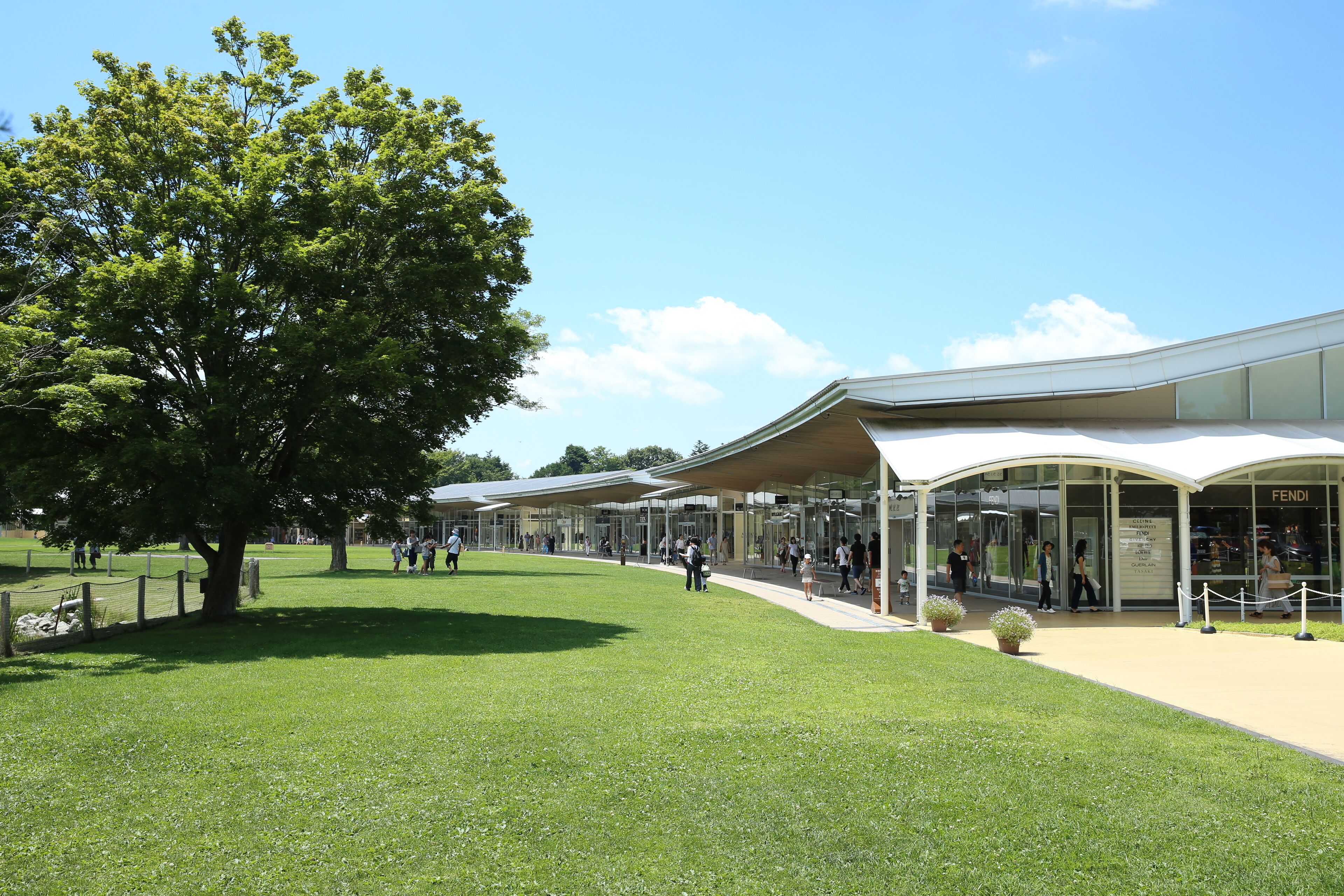 A modern building with a glass facade and a covered walkway.