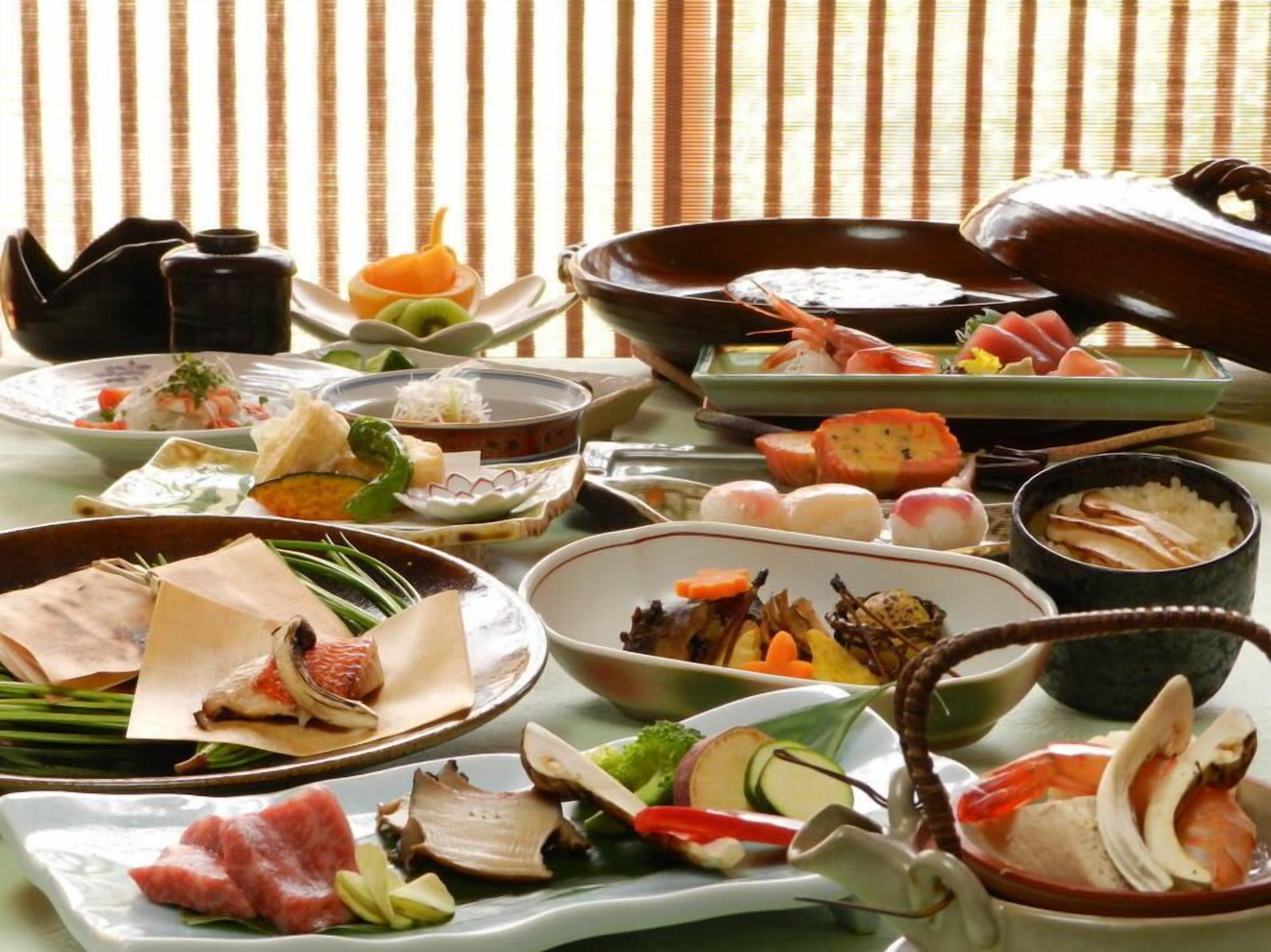 A variety of Japanese dishes arranged on a table with traditional bowls and plates.