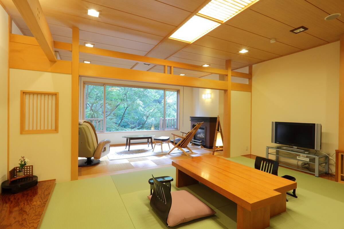 japanese style room with flooring living room, non smoking | living area | flat-screen tv