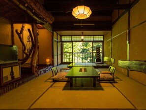 A traditional Japanese-style room with tatami flooring, a low table, and cushions. - Honke Bankyu (Nikko)