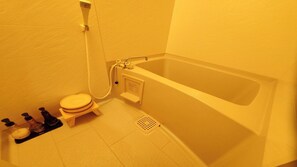 Un baño con bañera, inodoro y ducha.