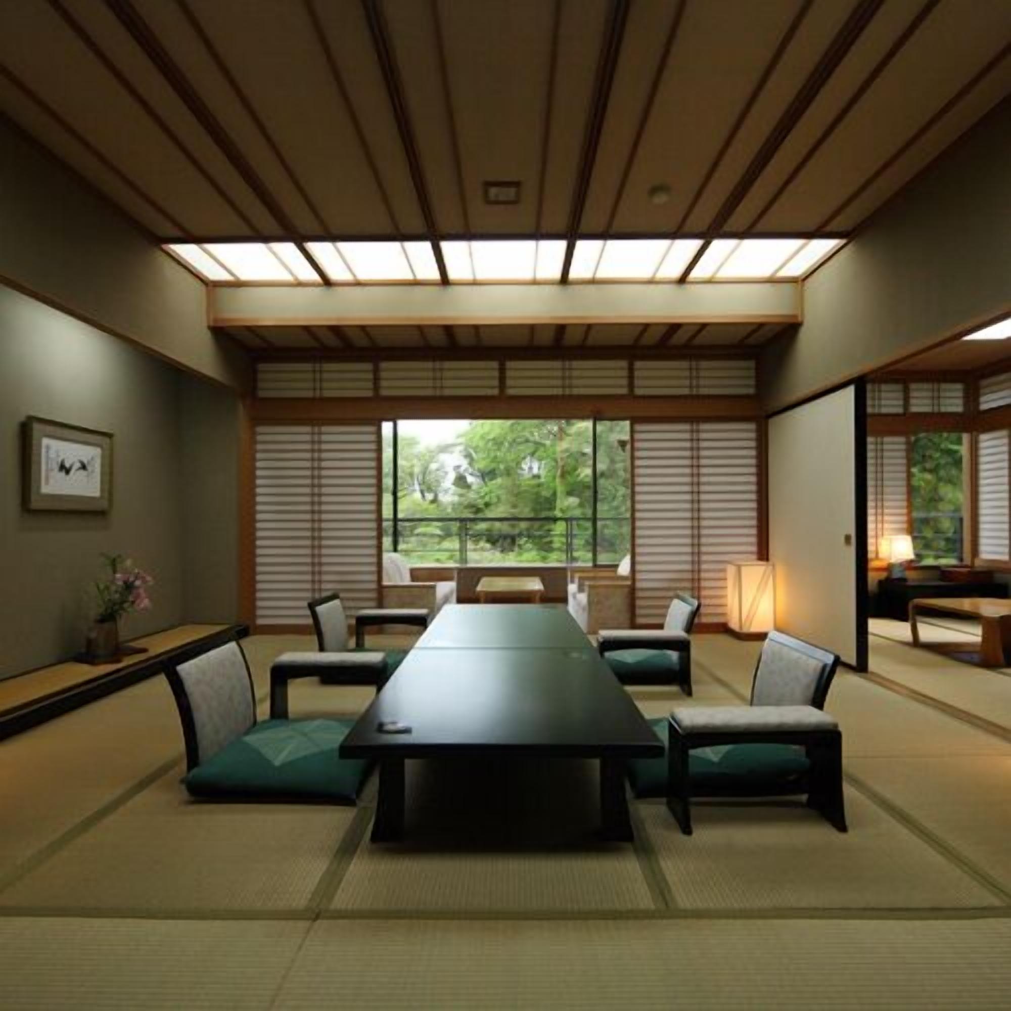 A traditional Japanese-style meeting room with tatami flooring, a low table, and sliding shoji screens.
