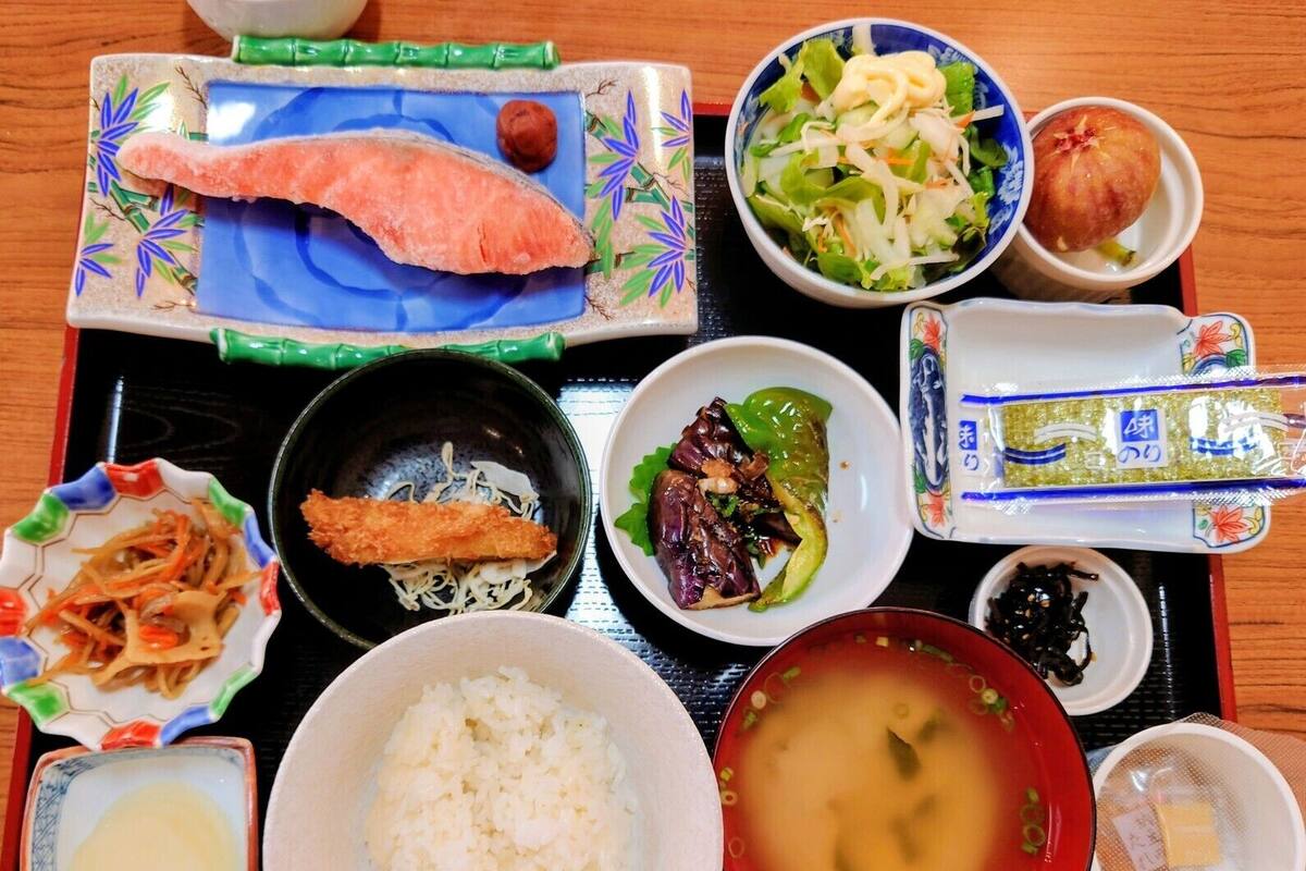 A traditional Japanese meal with various dishes including rice, fish, and vegetables.