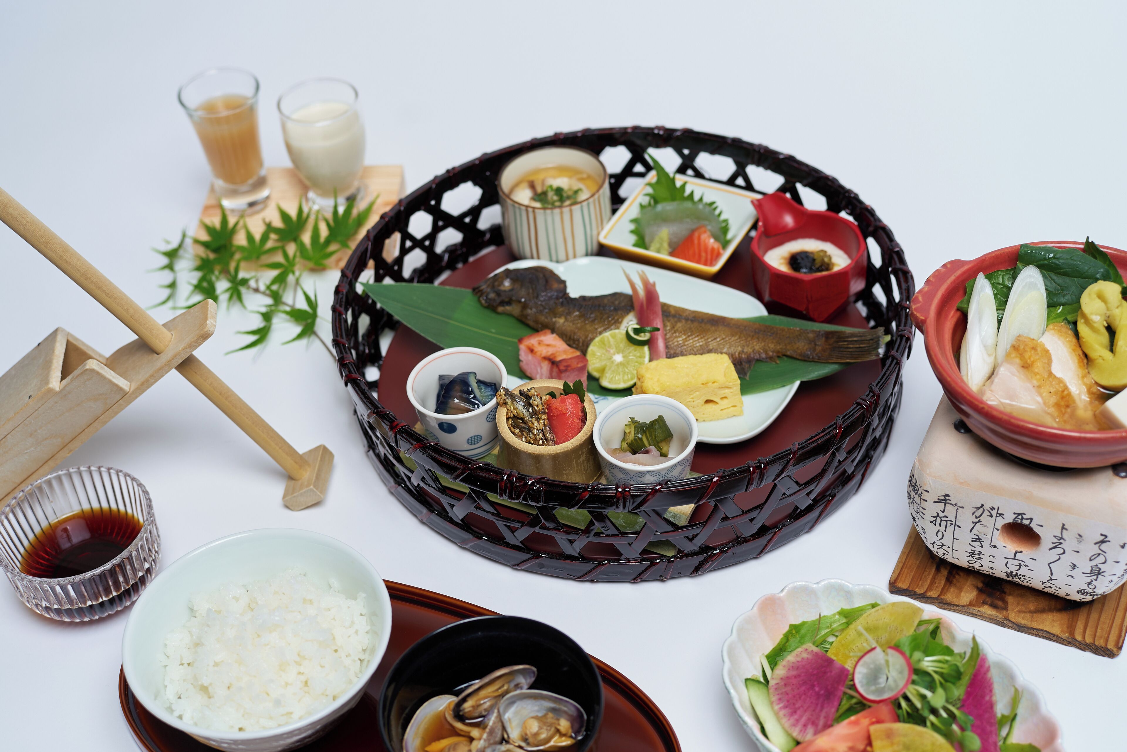 A traditional Japanese meal with various dishes and utensils on a table.
