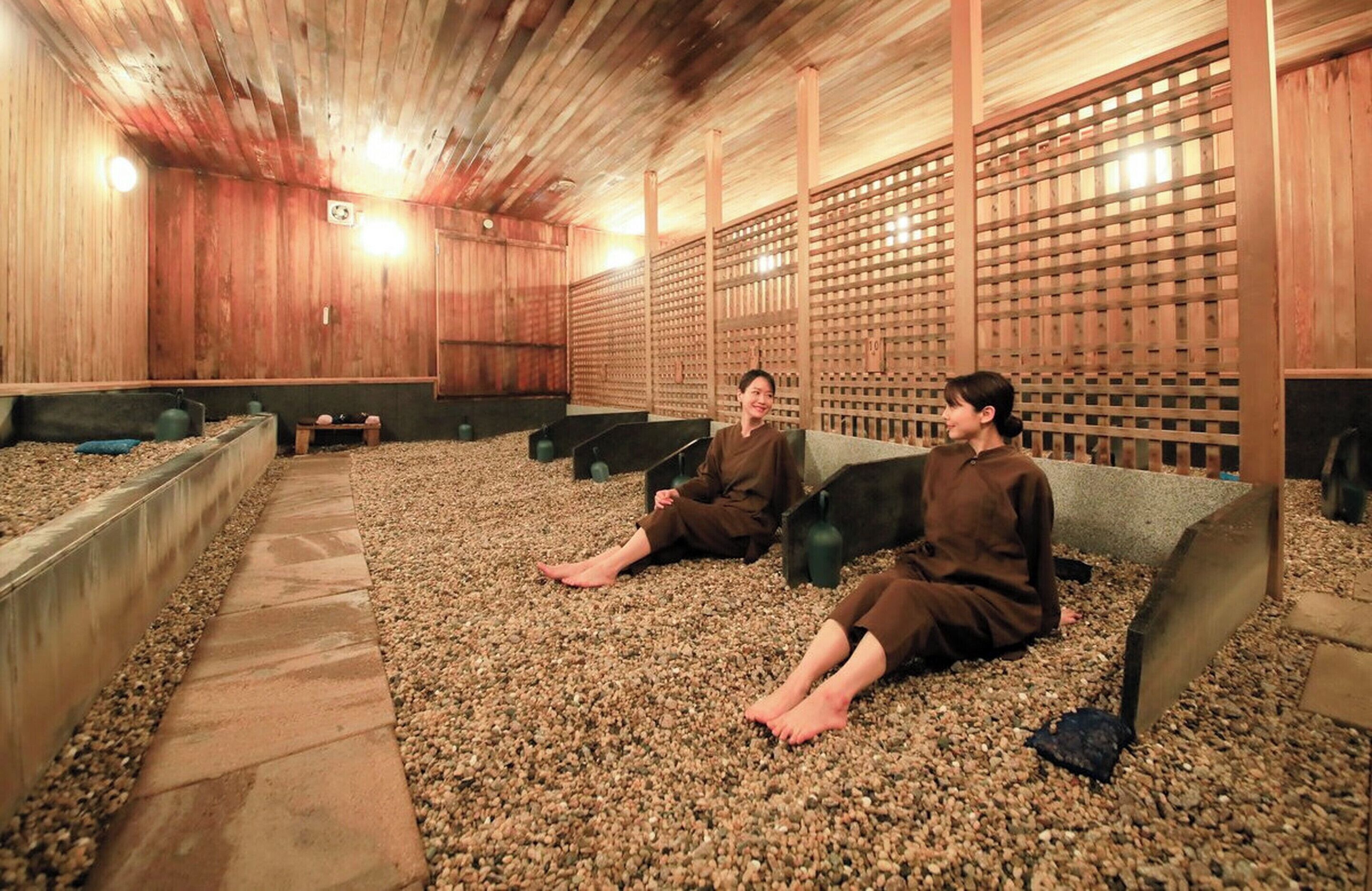 Um onsen japonês tradicional com paredes de madeira e piso ladrilhado.