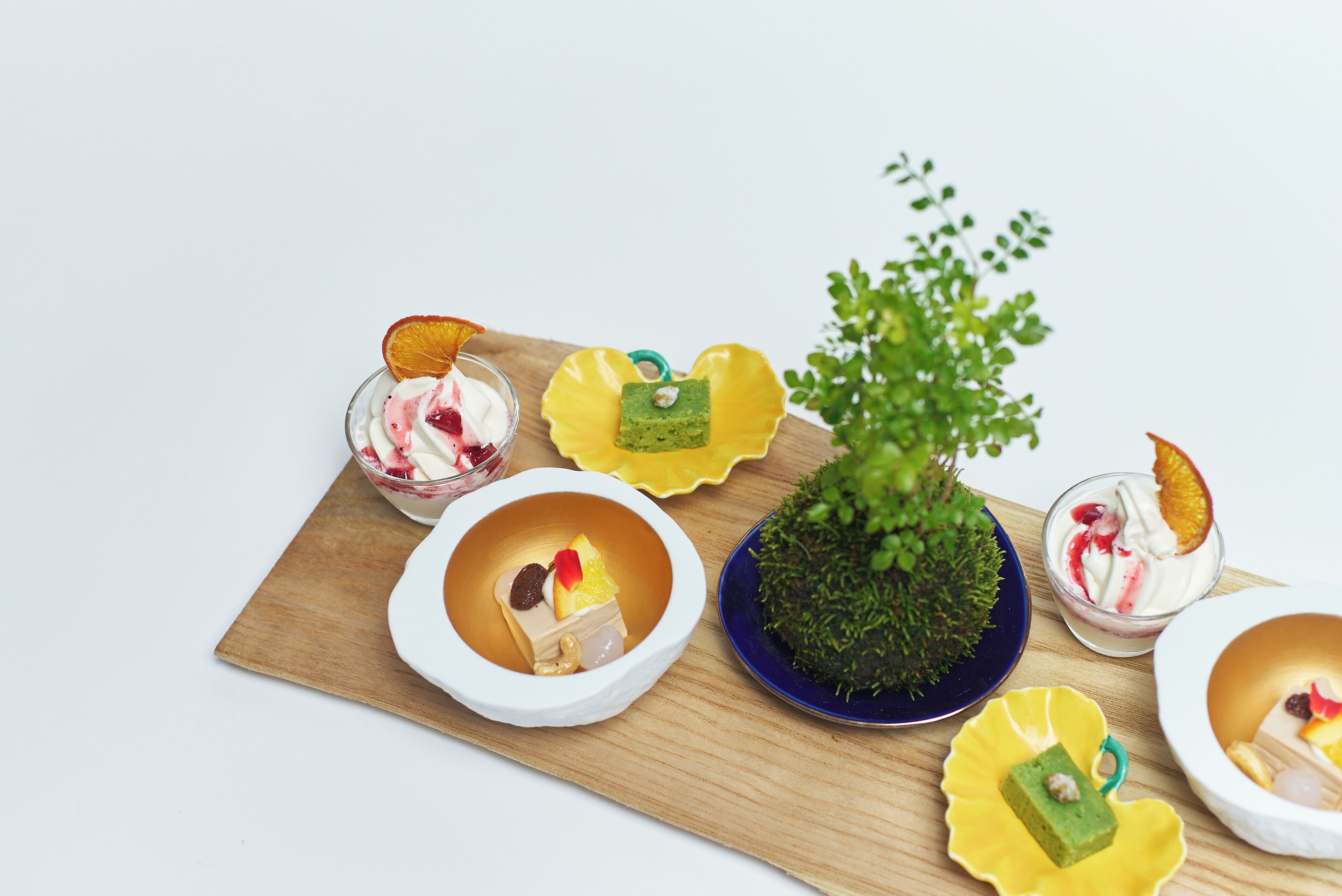A variety of desserts arranged on a wooden board.