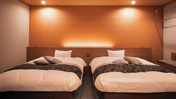 A hotel room with two beds, wooden headboard, and recessed lighting.