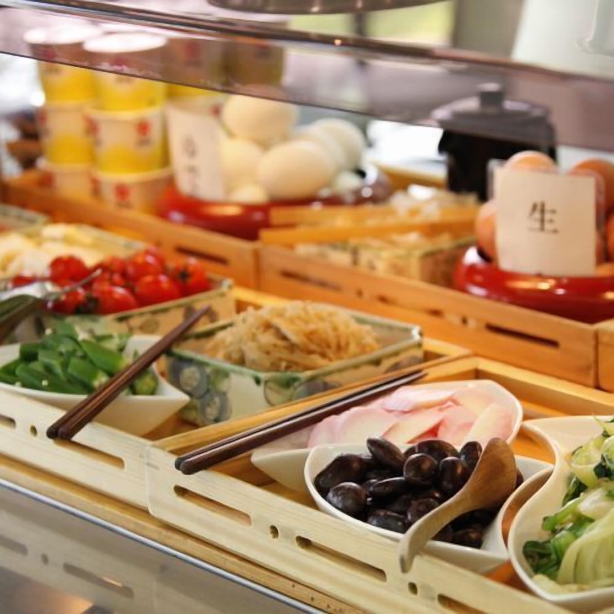 A buffet with various food items including vegetables, seafood, and other dishes.