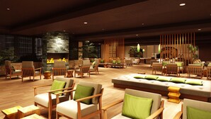 A spacious lobby with multiple seating areas, a fireplace, and a large plant. - Ooedo Onsen Monogatari Premium Kinugawa Kanko Hotel (Nikko)