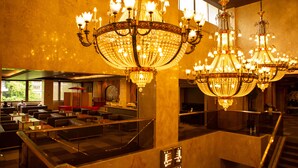 A spacious hotel lobby with multiple chandeliers, seating areas, and a staircase. - Ooedo Onsen Monogatari Premium Kinugawa Kanko Hotel (Nikko)