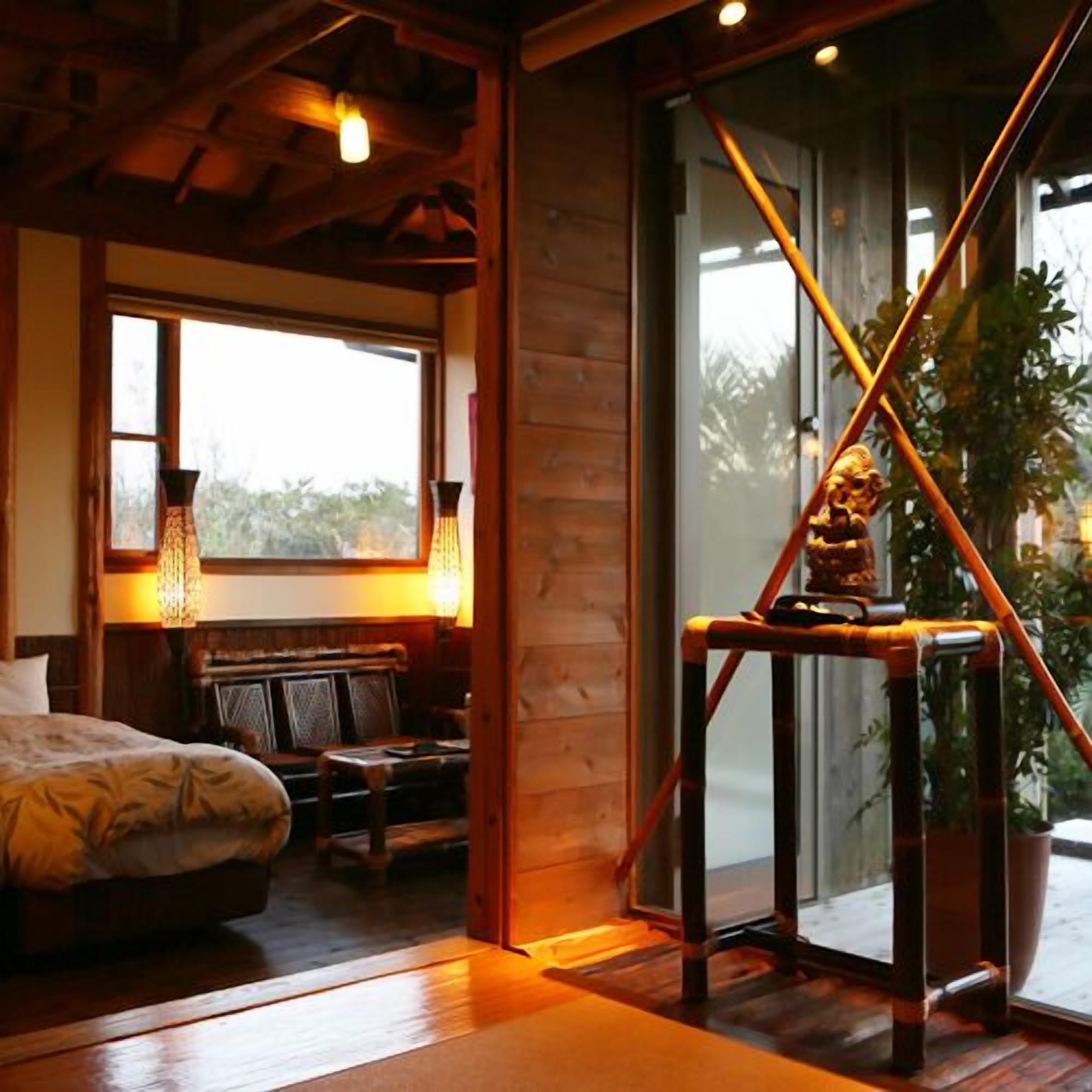 A wooden interior with a bed, a bench, and a table.