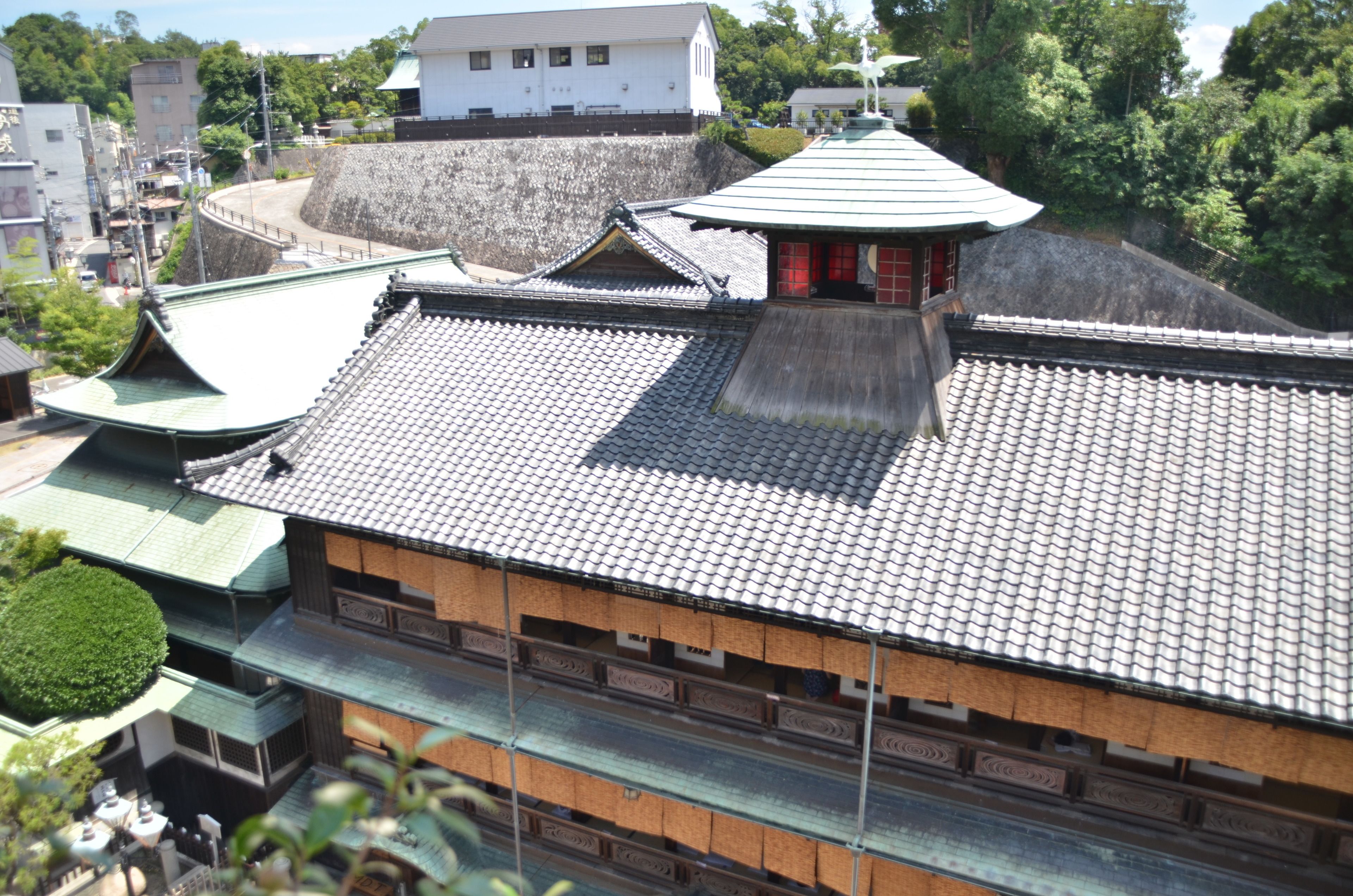 A traditional Japanese building with a tiled roof and wooden structure.