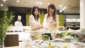 A buffet setup with various dishes and a chef in the background. - Hoshino Resorts Bandaisan Onsen Hotel (Bandai)