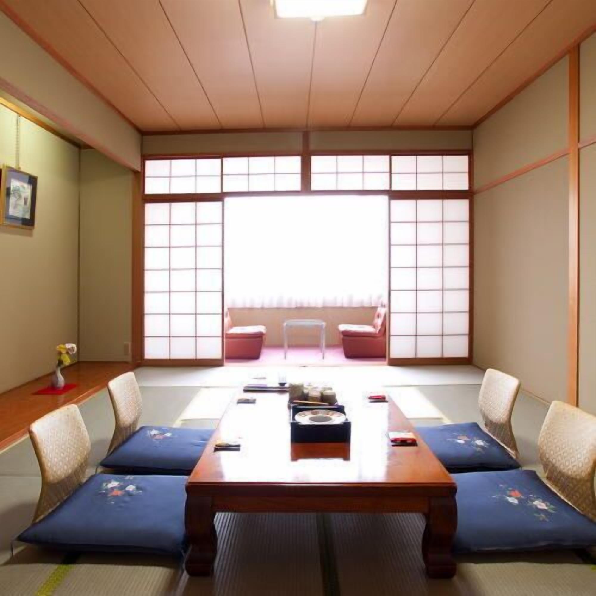 A traditional Japanese room with tatami flooring, a low wooden table, and shoji screens.