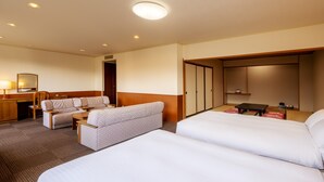 A hotel room with two beds, a sofa, a desk, and a wardrobe. - Mercure Miyagi Zao Resort & Spa (Zao)