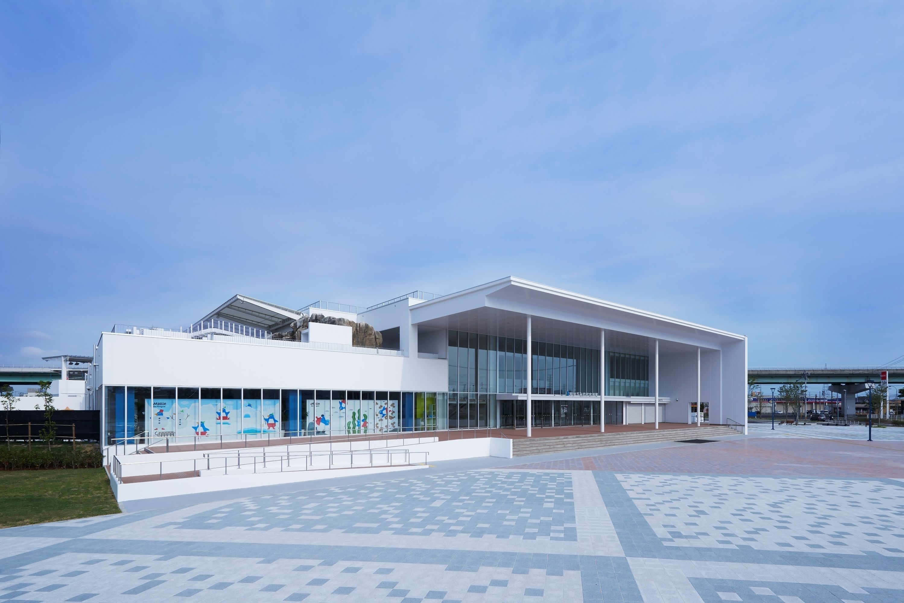 A modern building with large glass windows and a flat roof.