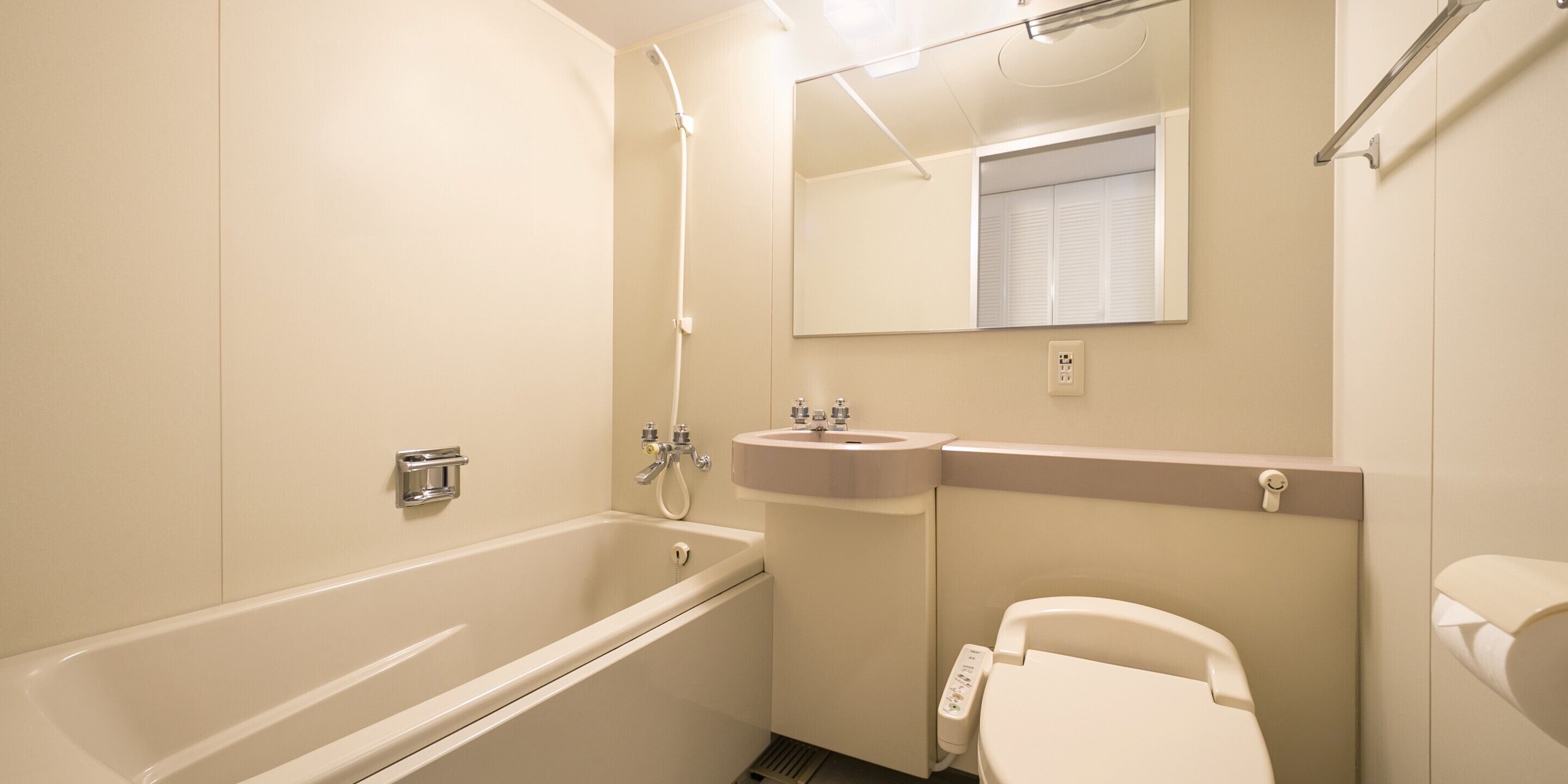 A bathroom with a bathtub, sink, and toilet.