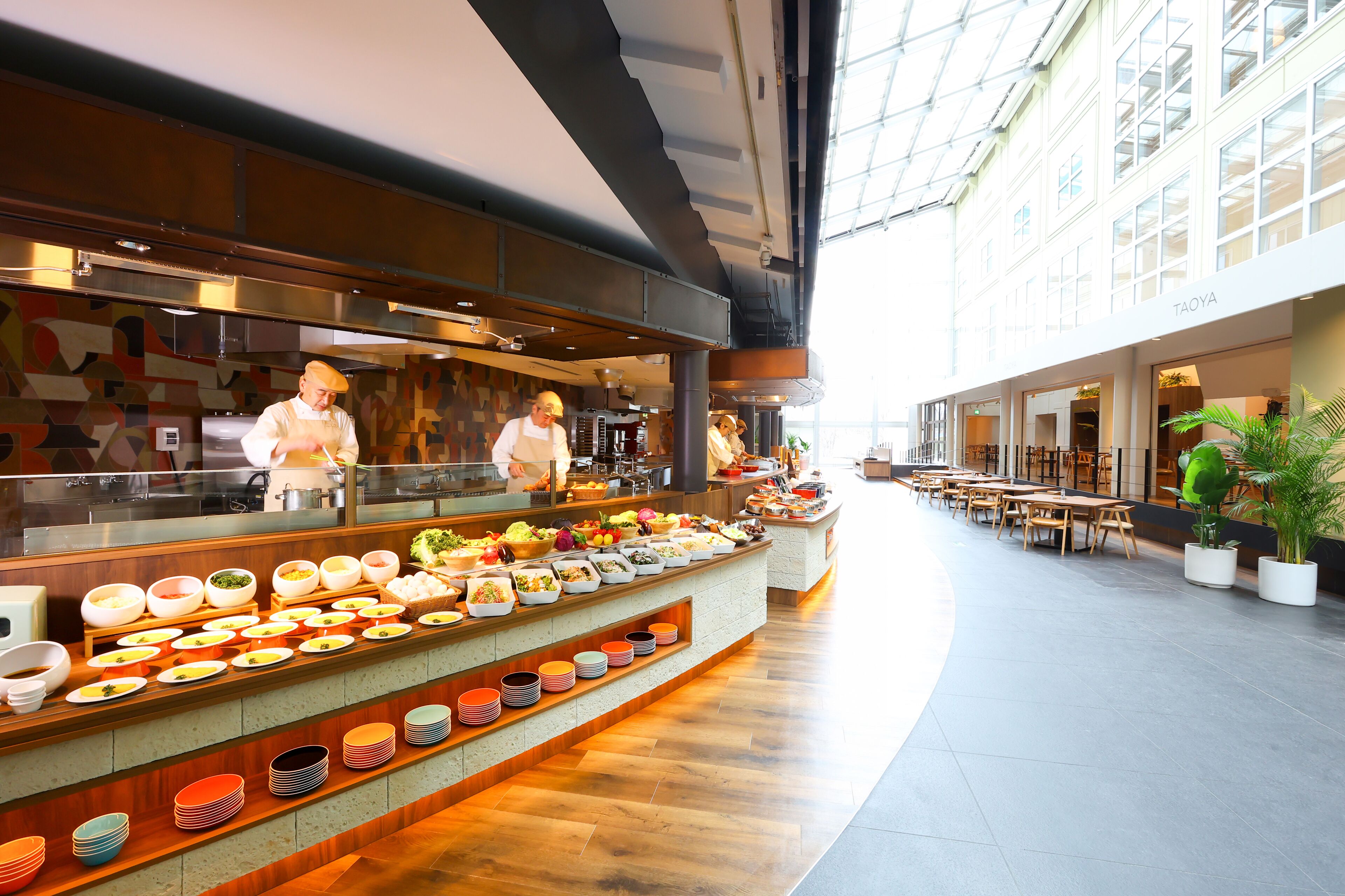 A buffet area with a variety of food options and a seating area with tables and chairs.