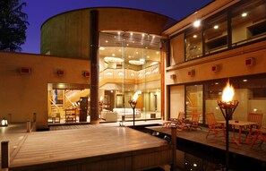 A modern hotel with a spacious outdoor deck, a pool, and a dining area with outdoor seating. - Kounkan (Shibukawa)