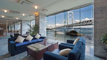 Enjoy a serene view of the bridge over the water from the comfort of this elegantly furnished living area.