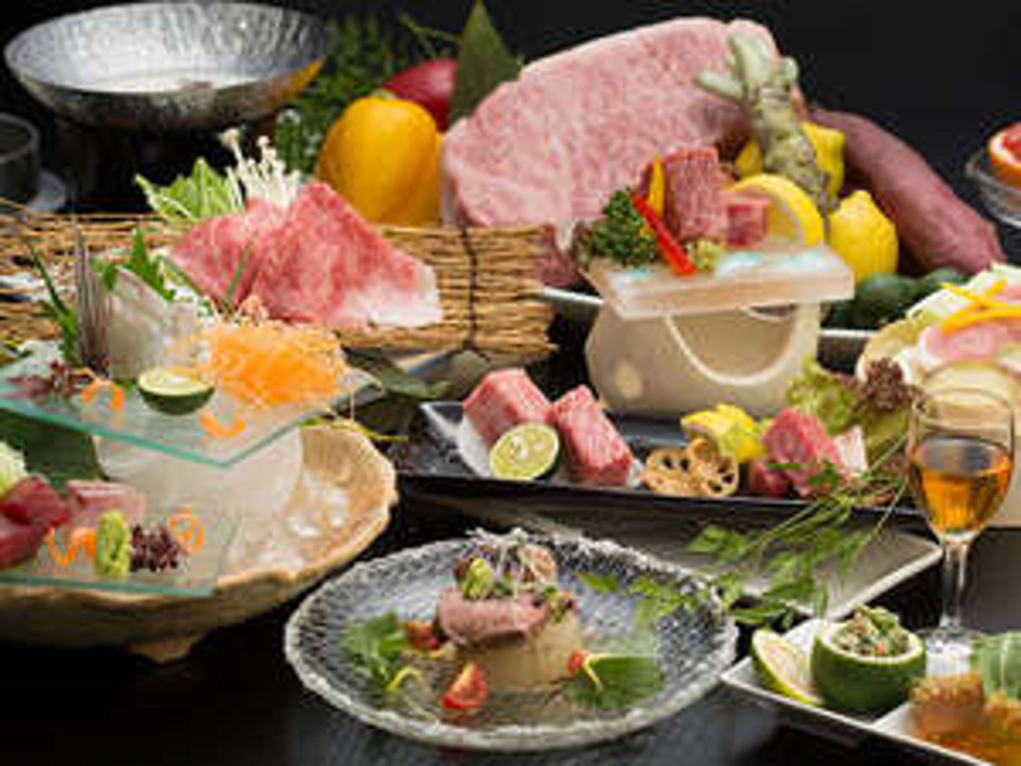 A variety of food items including meats, fruits, and vegetables arranged on a table.