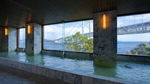 A spa area with a view of a bridge and water feature. - Bay Resort Hotel Naruto Kaigetsu (Naruto)
