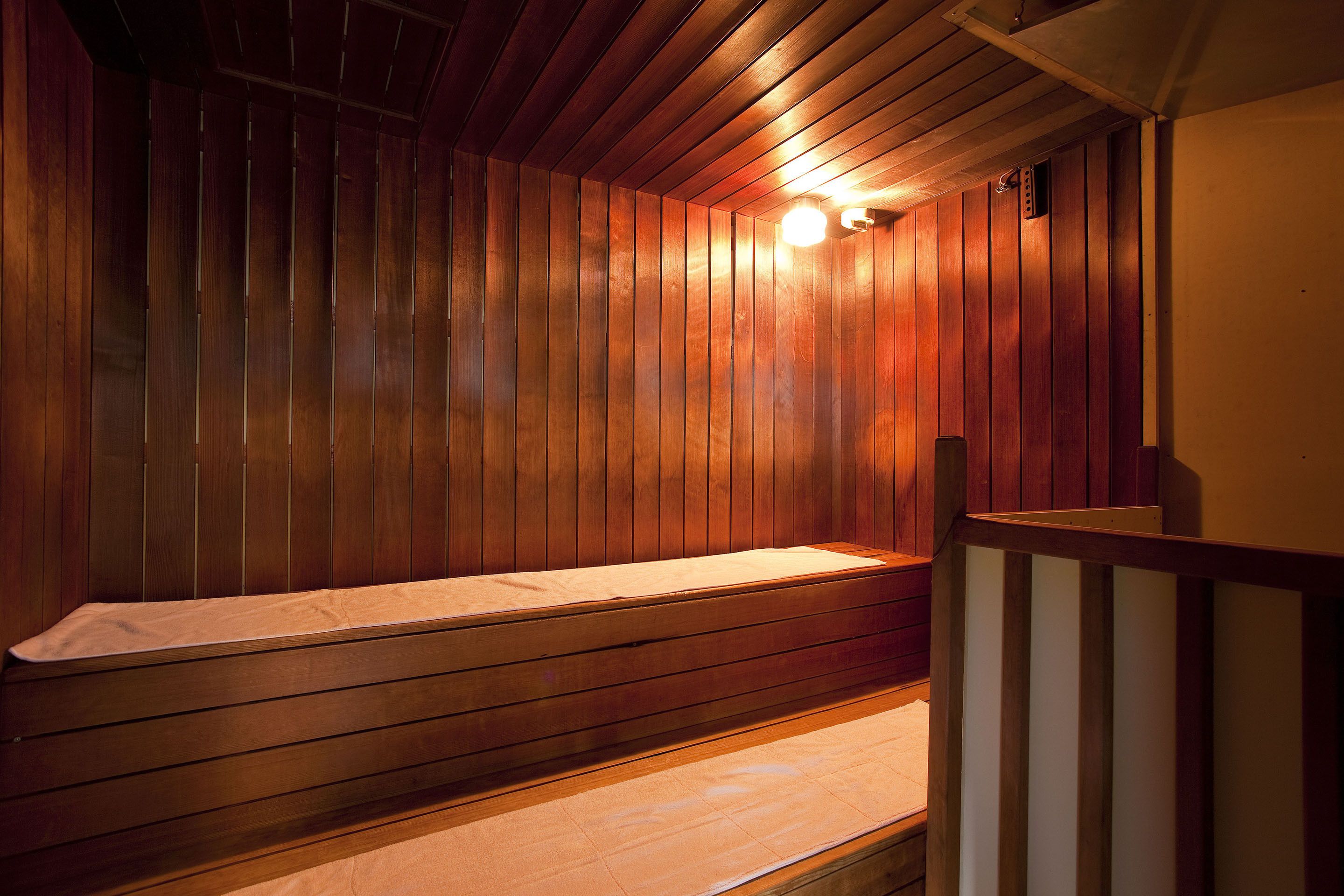 A sauna with wooden walls and a bench.