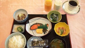 A tray with various Japanese dishes including rice, fish, and soup, along with drinks and a cup of coffee. - Hotel Sunroute Sano (Sano)