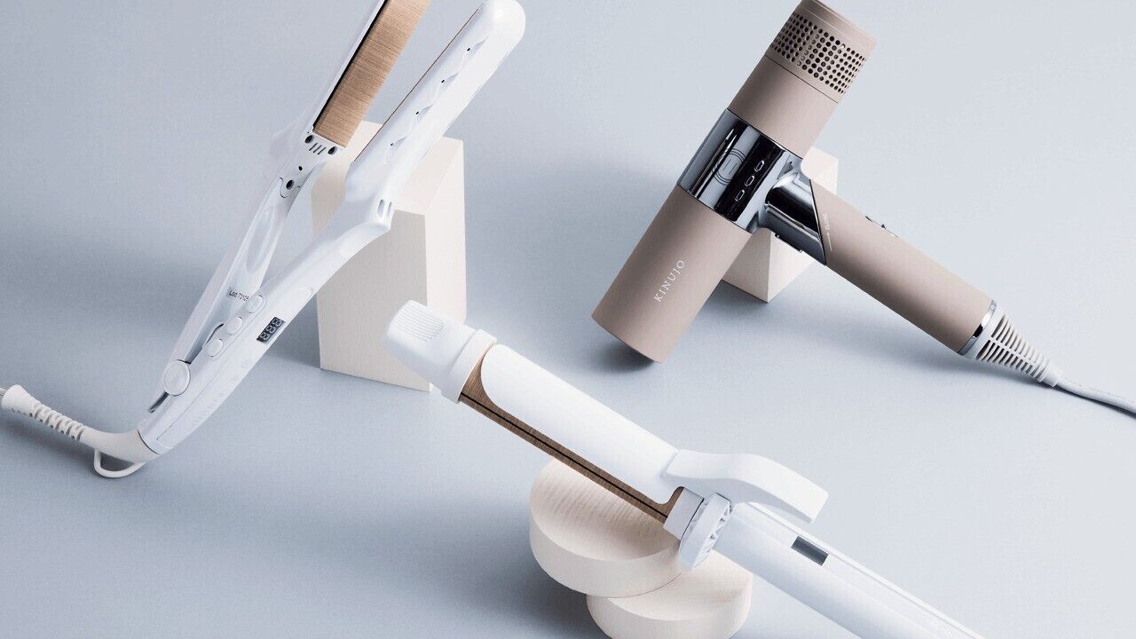 A modern, minimalist room with a neutral color palette, featuring a white desk, a beige chair, and a microphone stand.