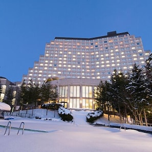 A large hotel with a modern design, featuring a prominent entrance and multiple floors.