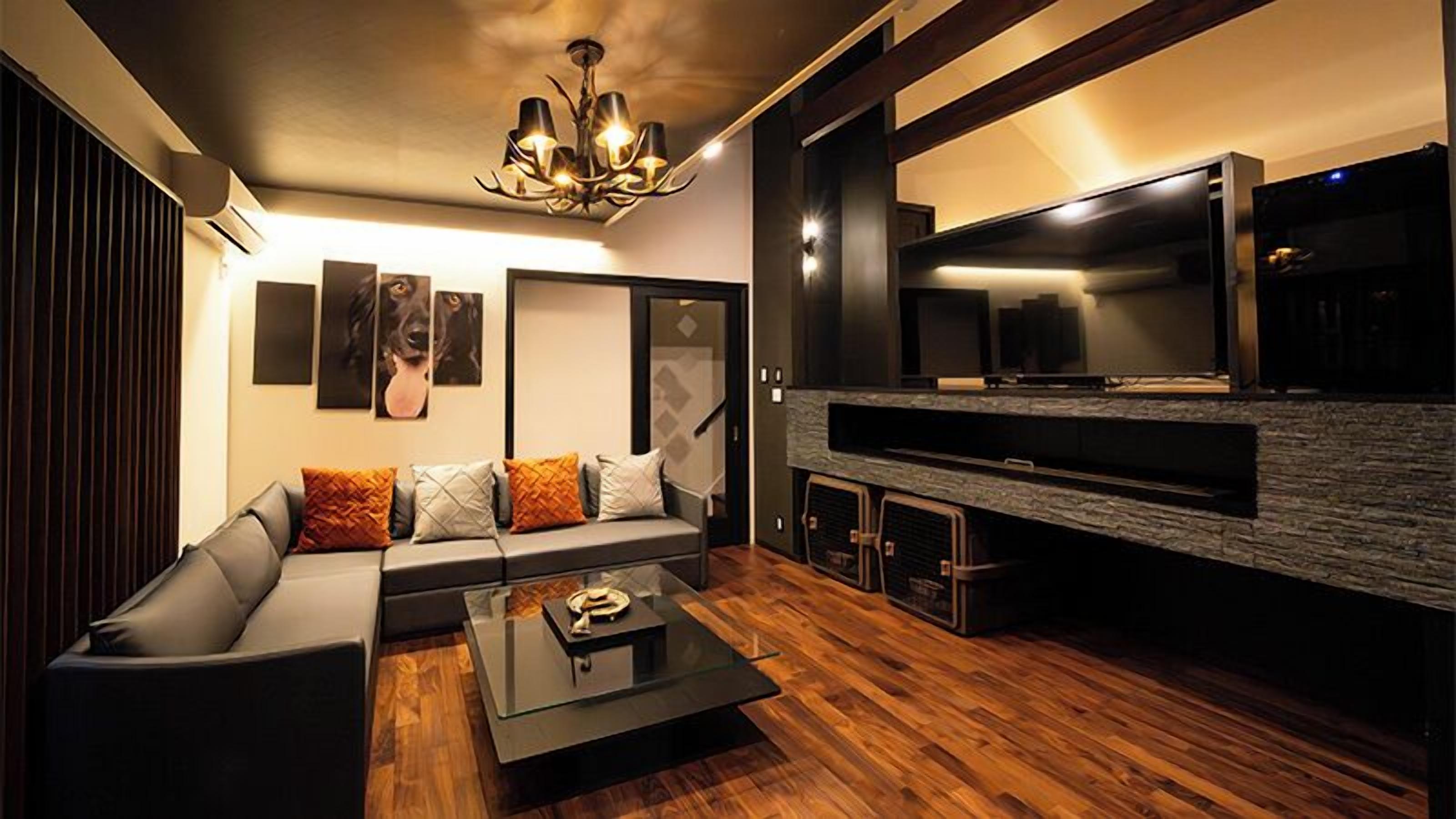 A modern living room with a sofa, coffee table, and a fireplace.