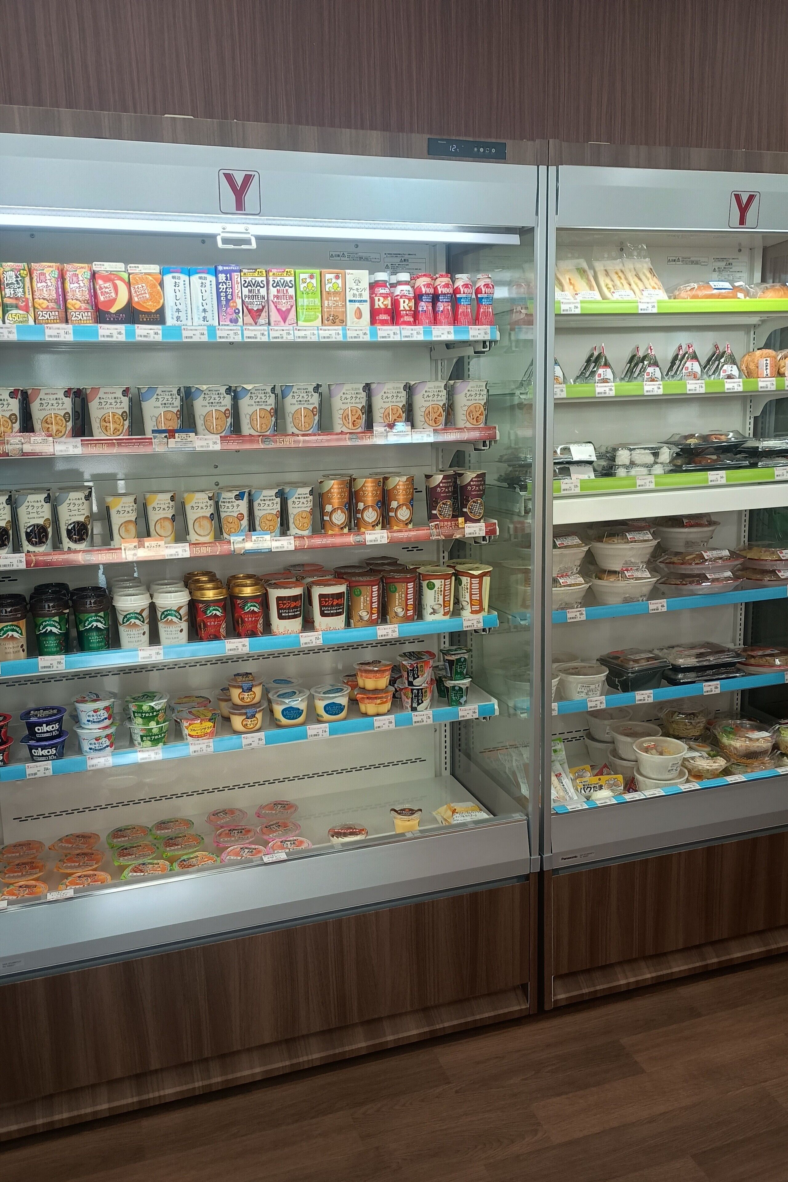 A refrigerated display case in a store with various food items.