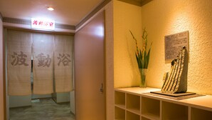 A hotel entrance with a sign reading "Hotel Name" and a reception desk with a vase of flowers. - Hotel Sunroute Tochigi (Tochigi)