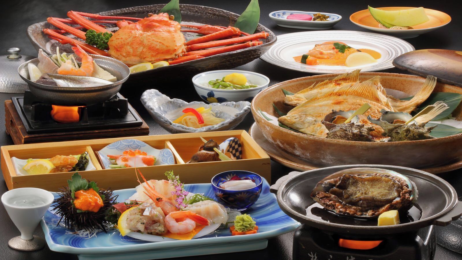 A variety of seafood dishes, including shrimp, crab, and fish, arranged on a table.
