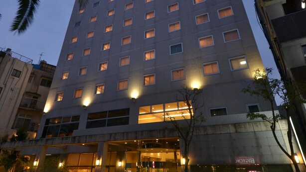 A multi-story hotel with a modern design, featuring a prominent entrance with glass doors and a well-lit facade. - Bright Park Hotel (Kochi)