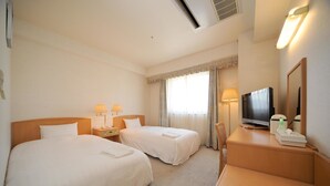 A hotel room with two beds, a desk, a television, and a window with curtains. - Bright Park Hotel (Kochi)