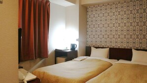 A hotel room with two beds, a desk with a telephone, and a patterned headboard. - Hamamatsu Station Hotel (Hamamatsu)