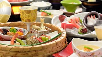 A variety of dishes and bowls on a table, including sushi, sashimi, and other seafood.