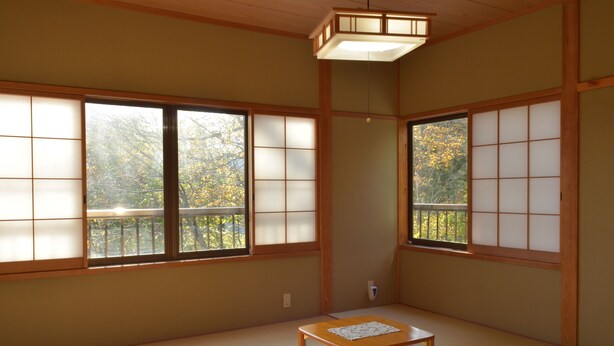 A traditional Japanese room with tatami flooring, sliding shoji doors, and a wooden table. - Sora Tobu Usagi (Myoko)