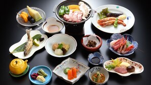 A variety of dishes including seafood, vegetables, and a teapot on a table.