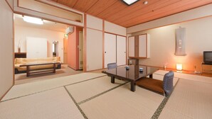 A traditional Japanese-style room with tatami flooring, a low table, and a sofa. - Subaruyado Yoshino (Tokushima)