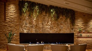 A stone wall with a fire feature and seating area. - Yu No Mori Hotel Shidotaira (Hanamaki)