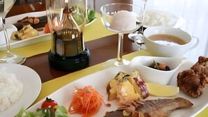 A dining table with various dishes including fish, rice, and vegetables. - Guest House Hilltop (Nagano)