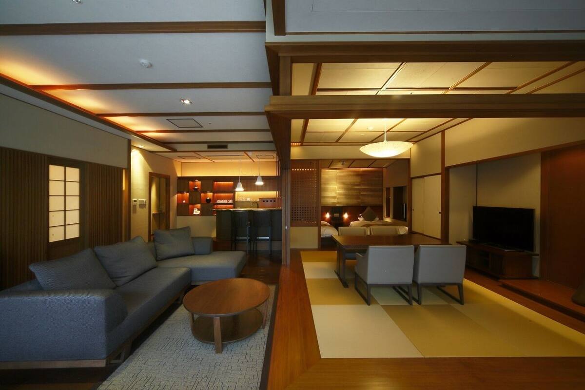 A modern living room with a sofa, coffee table, and TV.
