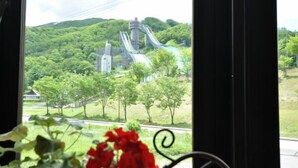 A view of a park with a water slide and trees.