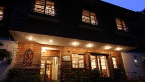 A two-story building with a wooden facade, large windows, and a sign that reads "Pension Yasuda." - Inn of Amigos Yasuda Pension (Takayama)