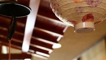 A ceiling with a hanging lamp and a decorative paper lantern.
