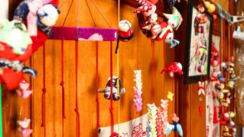 A room with wooden walls and a variety of hanging decorations, including plush toys and colorful ornaments.